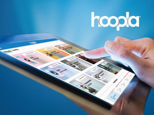 Person holding tablet using hoopla app